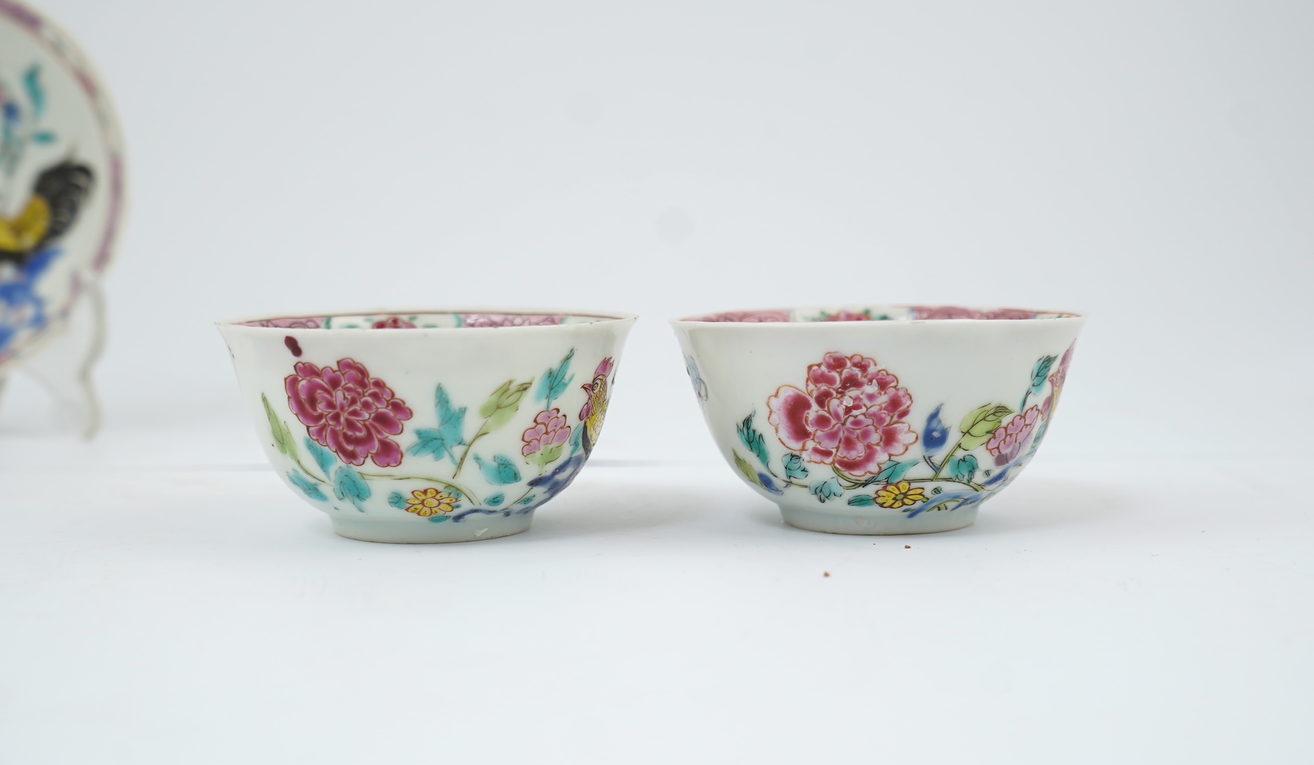 A near pair of Chinese famille rose ‘cockerel’ tea bowls and saucers, Yongzheng period